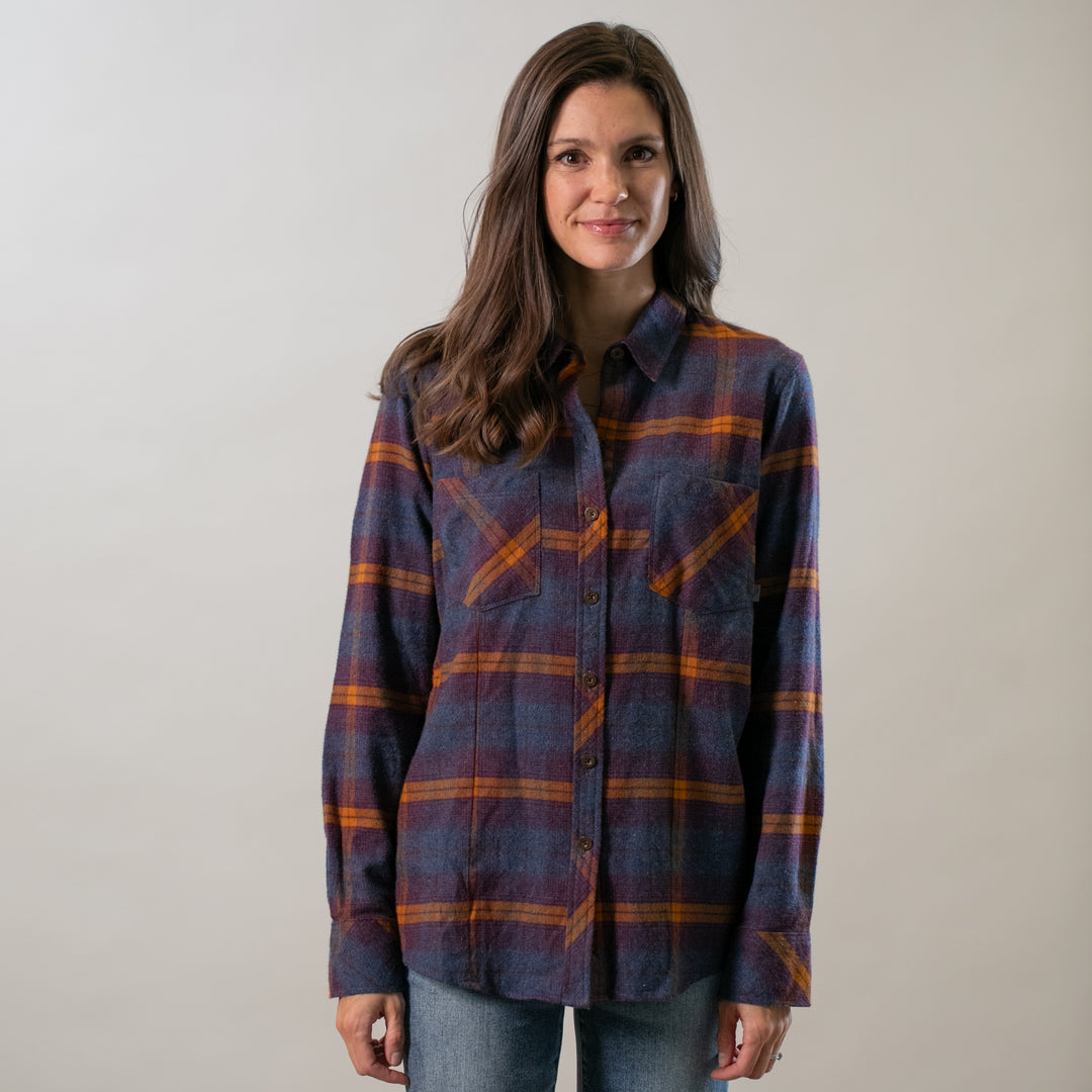 Woman smiling, wearing Pladra Women's Every Day Flannel Shirt in Portsmouth Blue Heather and jeans against plain background.