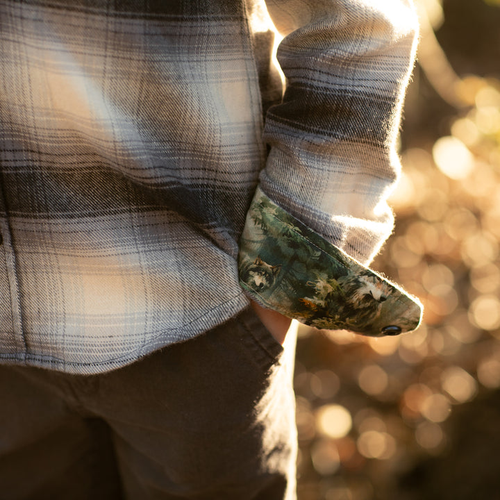 Toddler wearing a Pladra Cubs Flannel Shirt in Sterling Grey Heather, outdoors in warm sunlight.