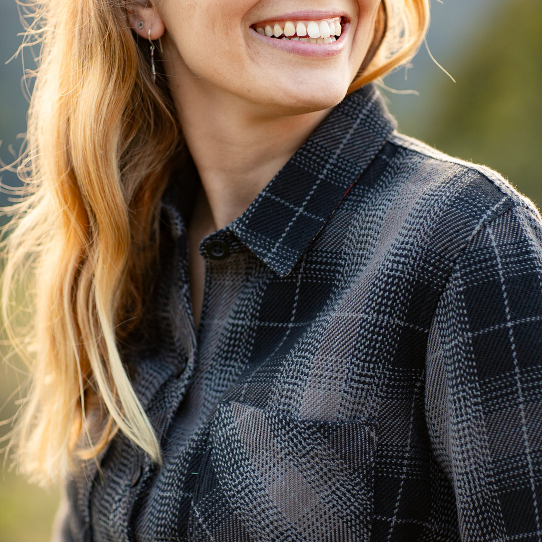 A woman with long blonde hair smiles outdoors in the Pladra Women&