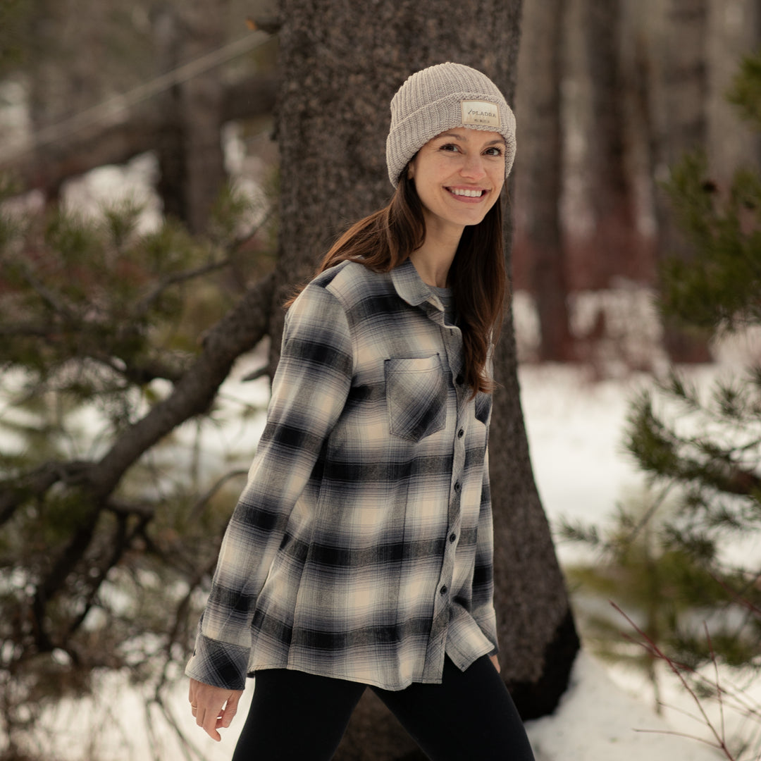 A woman in a beige knit beanie and the Women&