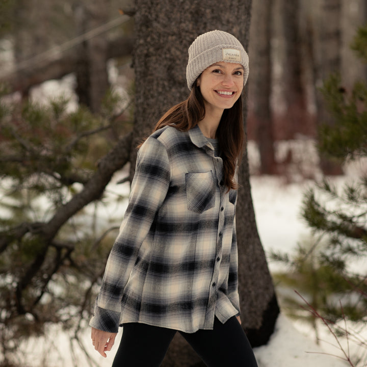 A woman in a beige knit beanie and the Women&