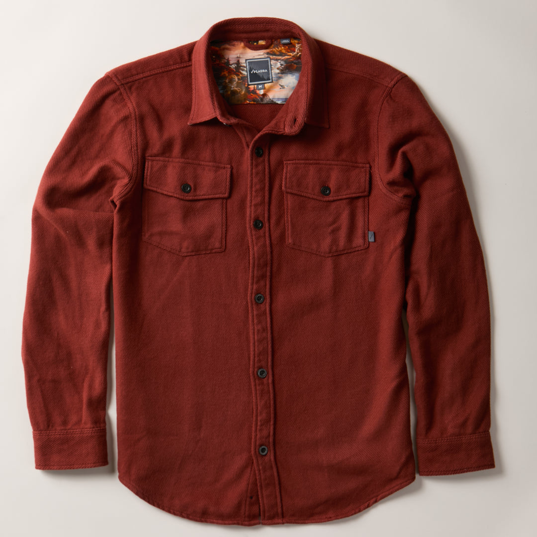 Pladra Men's Fireside Flannel in Brick Red, heavyweight with two chest pockets, laid flat on a light background.
