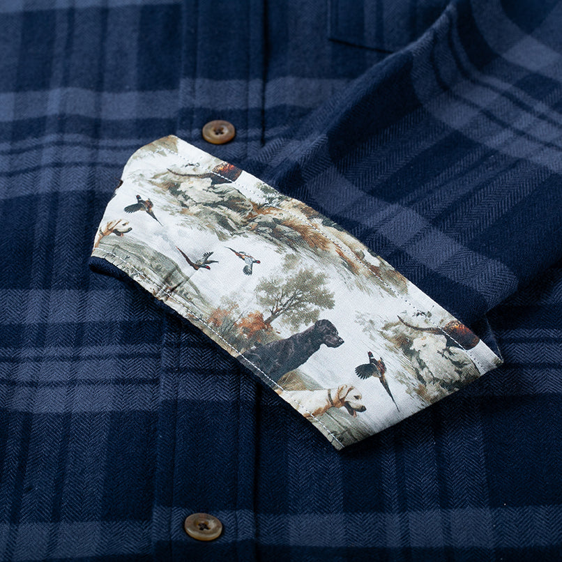 Pladra Men’s Every Day Flannel Shirt in Cloud Blue features turned-up cuffs with a dog and duck hunting scene lining.