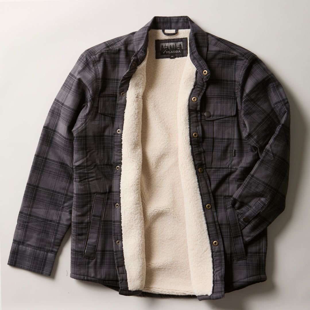 Pladra Men's Northwood Sherpa Insulated Flannel Jacket in Deadwood Black shown open on a white surface.