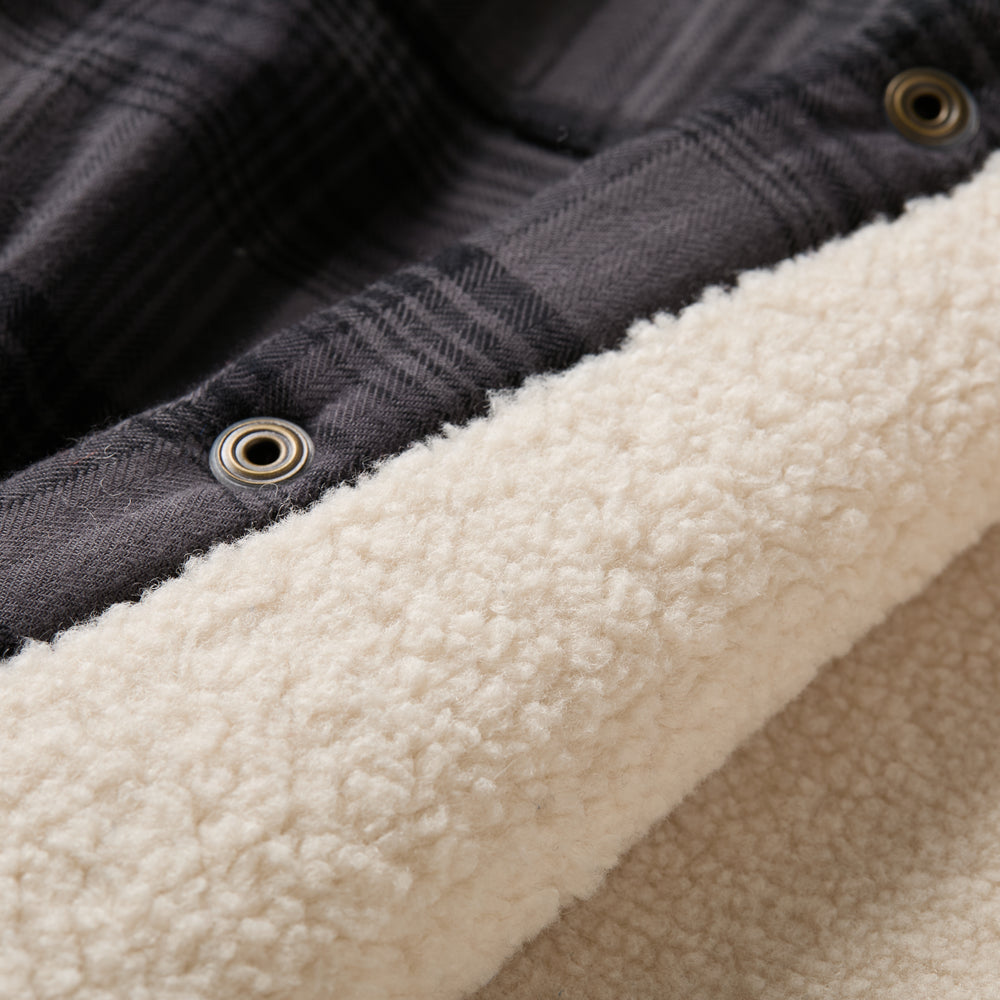 Close-up of Pladra Men's Northwood Sherpa Insulated Flannel Jacket in Deadwood Black with soft sherpa fleece lining.