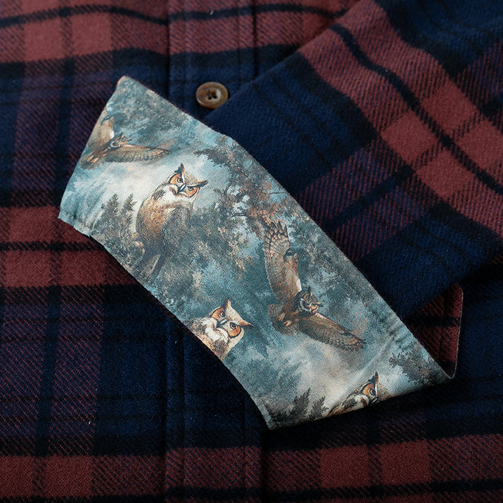 A cuff is flipped on the Pladra Men’s Every Day Elite Flannel, revealing a forest scene owl lining.