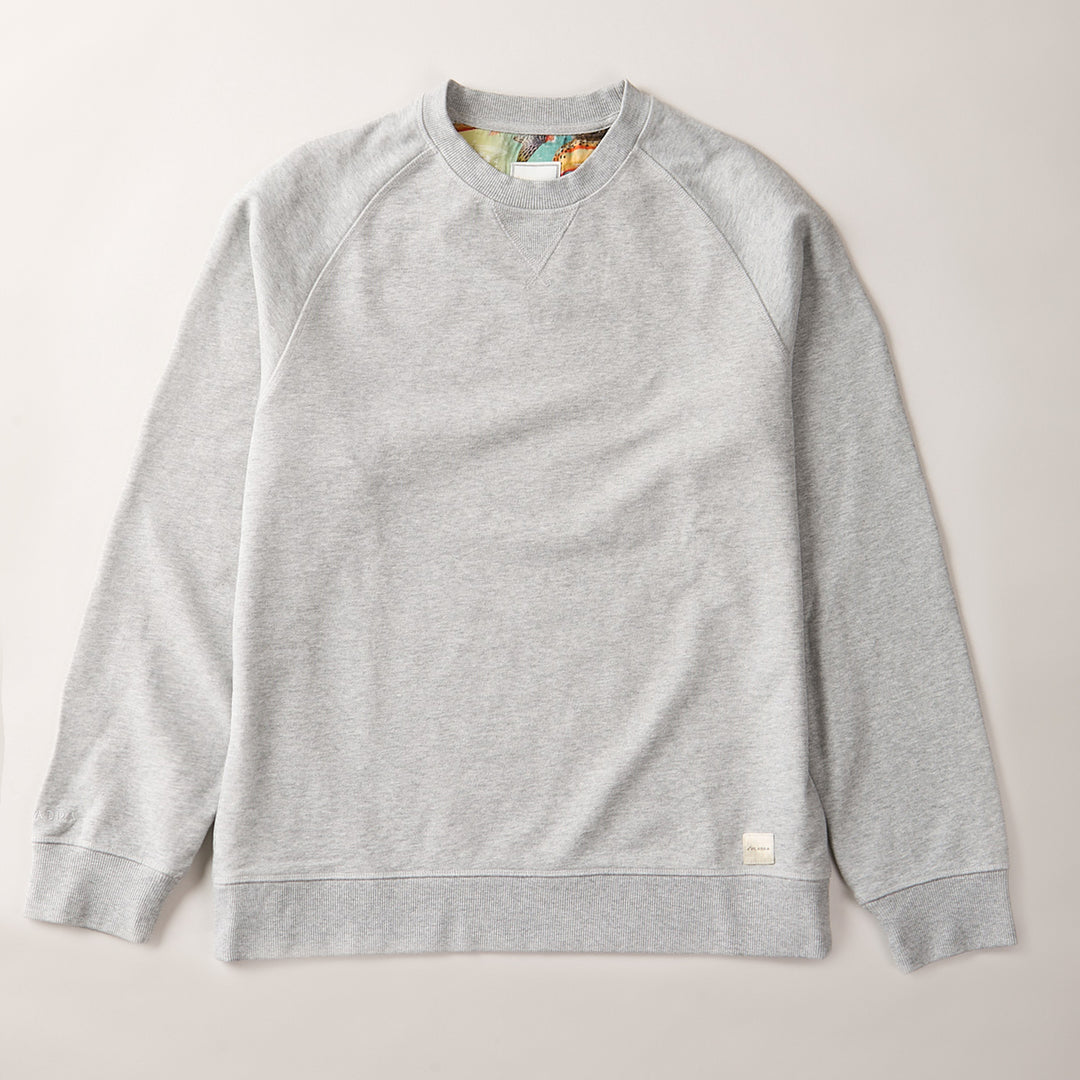 The Men's Klamath Crew in Fog Grey is a classic fit sweatshirt made from premium cotton French terry, featuring long sleeves and ribbed neckline, cuffs, and hem. Displayed flat on a neutral background with a small white tag near the bottom hem.