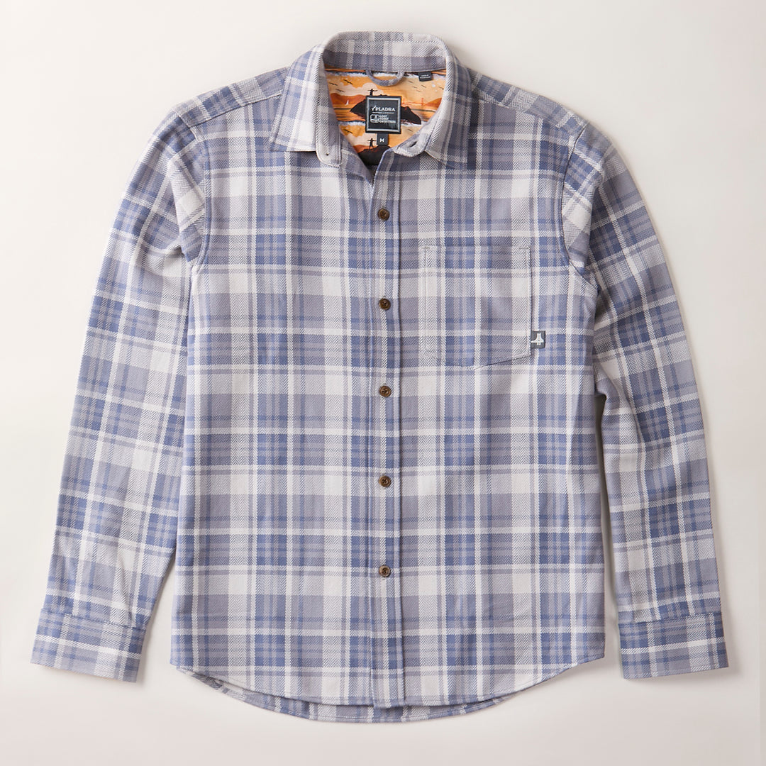 The Men's Every Day Elite Flannel Shirt in Geary Grey, crafted from heavyweight cotton flannel with a blue, gray, and white plaid pattern, features a single chest pocket and brown buttons, laid flat on a light background.