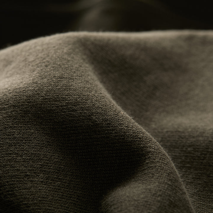 Close-up of the soft, textured pine green fabric on the Men&