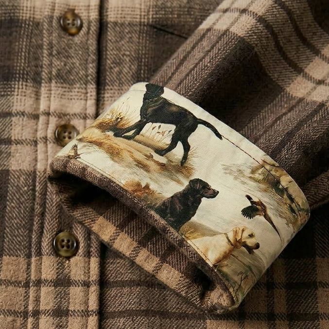 A close-up of the Men's Every Day Elite Flannel Shirt- Retriever Tan in brown plaid, featuring turned-up cuffs that reveal a dog-and-duck print lining. Made from soft, heavyweight flannel for warmth and style.