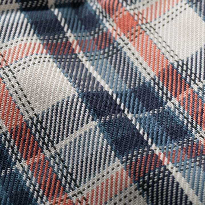 Close-up of a plaid fabric with blue, red, and gray colors.