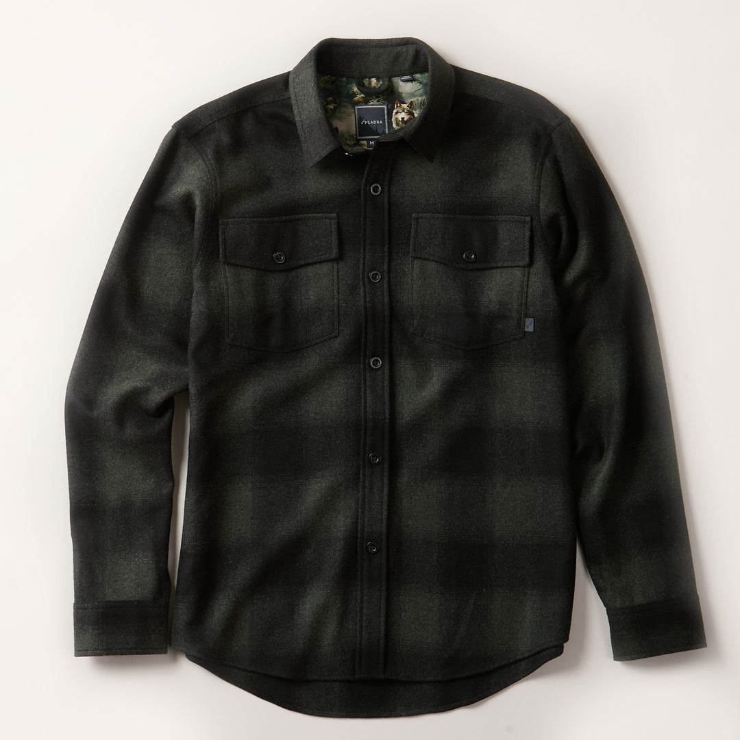 The Men's Workhorse Wool Flannel Shirt in Moss Green is a durable, long-sleeve button-up with a dark green and black plaid, two chest pockets with buttoned flaps, shown laid flat on a light background.