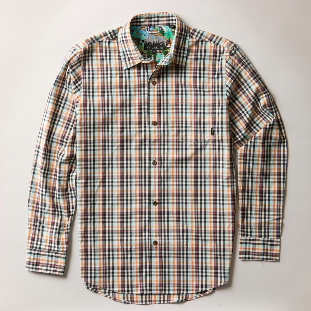 The Men's Tailwinds Shirt in Pebble Brown is a lightweight poplin, long-sleeve button-up featuring a blue, brown, and white multicolored plaid pattern, displayed flat on a light background.