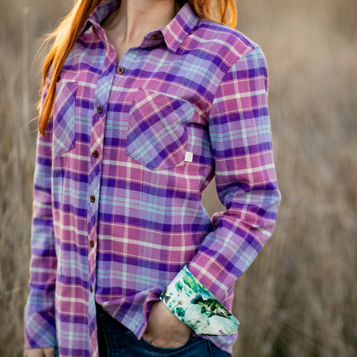 Woman with long red hair wears Pladra&