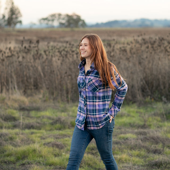 A woman with long red hair smiles in a Pladra Women&