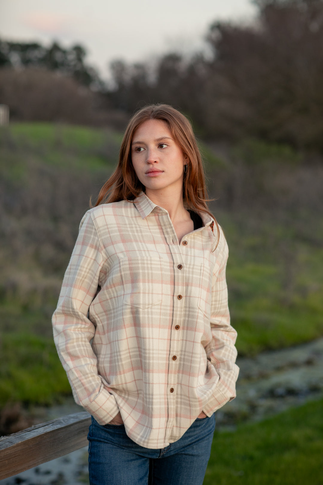 A young woman with long brown hair, wearing the Women&