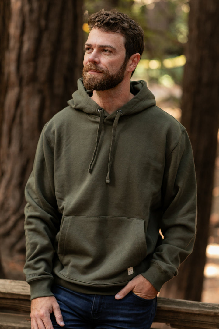 A bearded man wearing the Men&