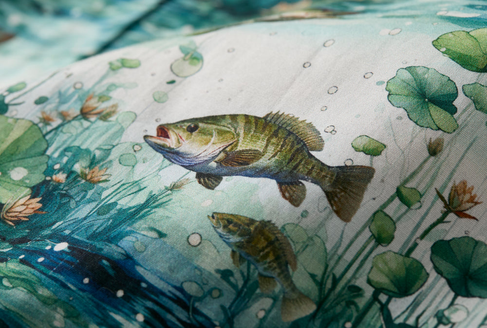 Bass swimming among lily pads in clear water, featured on Pladra Men's S/S Printed Outdoor Aloha Shirt - Bass.
