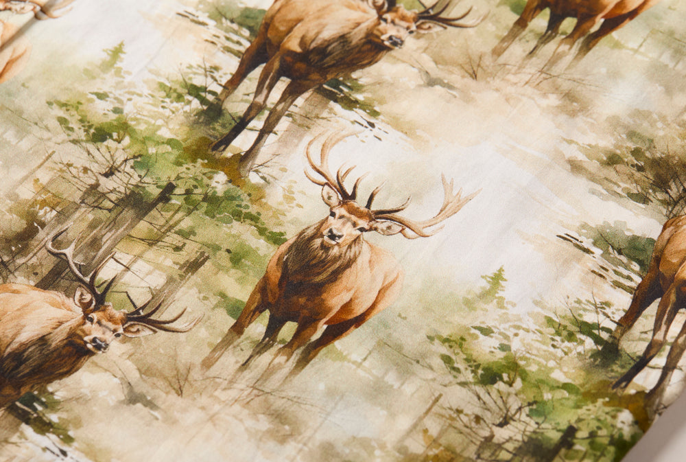 The Men's S/S Printed Outdoor Aloha Shirt - Elk showcases repeated illustrations of brown elk with large antlers in a watercolor-style green and beige forest, ideal for outdoor wear or as a stylish Hawaiian shirt.