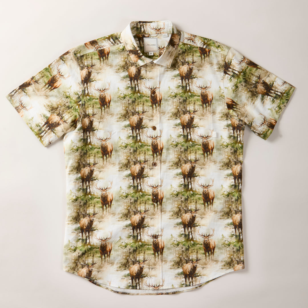 The Men's S/S Printed Outdoor Aloha Shirt - Elk features an all-over elk and forest print in green, brown, and white tones. This stylish cotton summer shirt is displayed flat on a plain, light-colored background.