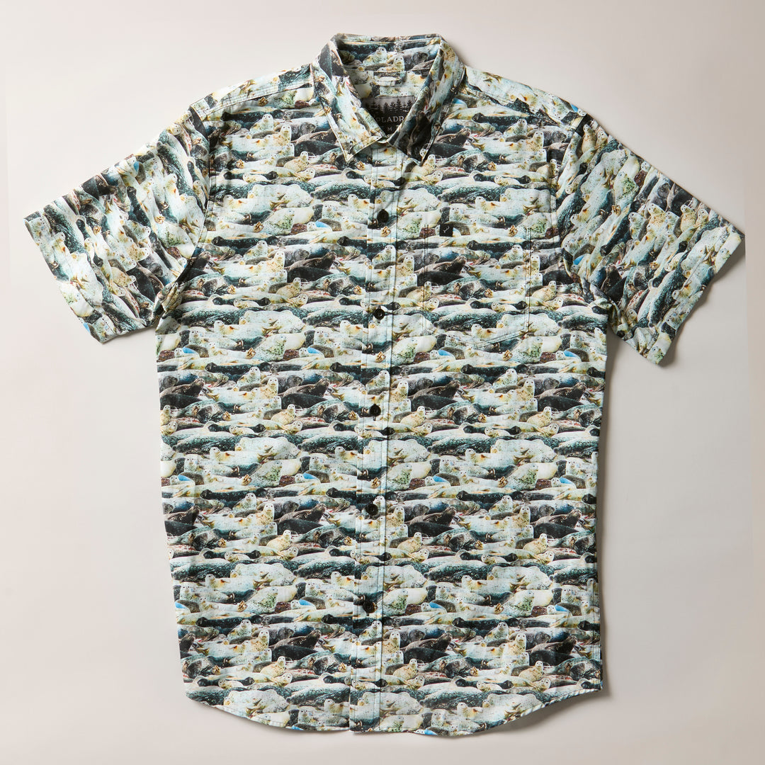 Pladra Men's S/S Printed Outdoor Aloha Shirt - Seals: 100% cotton, fish & river print, shown laid flat.