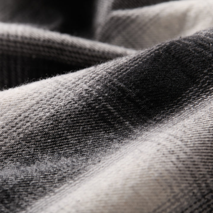 Close-up of the soft, black and white plaid fabric from the Men&
