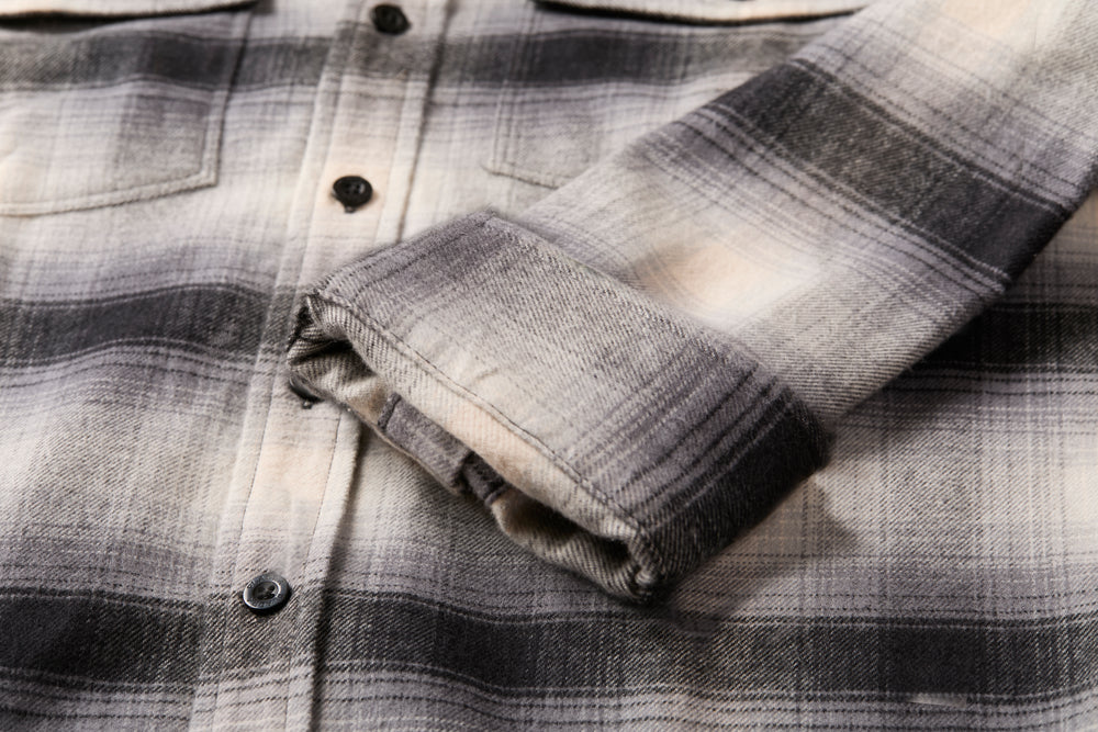 Pladra Men’s Workhorse Flannel Shirt- Sterling Grey Heather in grey and white with a buttoned front and folded cuffs.