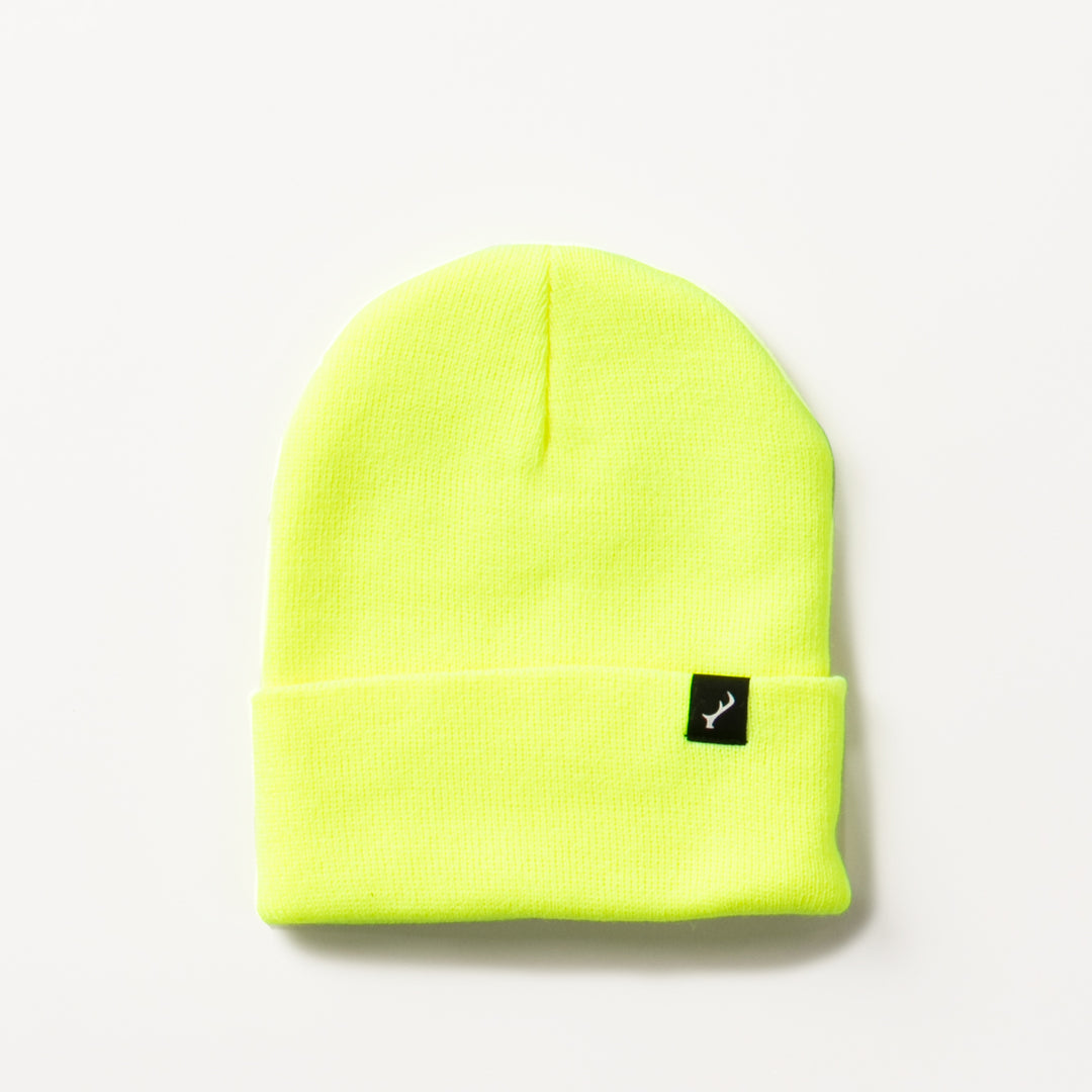Pladra Stretch Cuff Beanie in safety yellow with a folded brim and small black logo tag on the front.