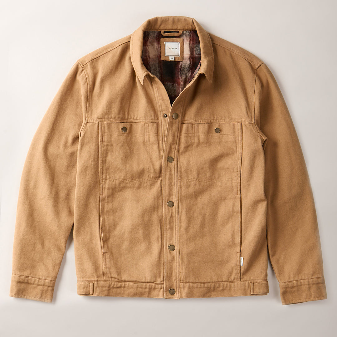 Pladra Men's Sequoia Jacket in Tobacco Brown with chest pockets, collar, and plaid flannel lining, laid flat on a light surface.