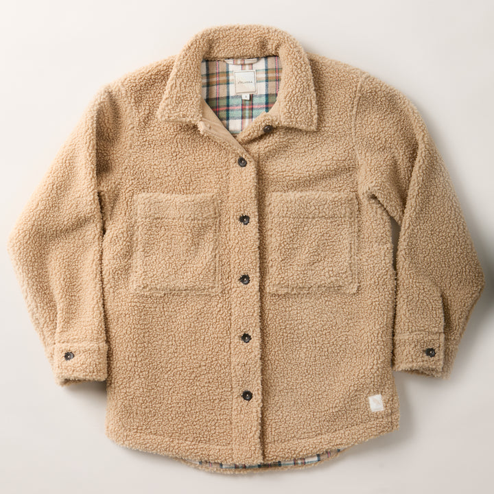 Pladra Women’s Headlands Sherpa Shacket in Almond Tan with chest pockets and plaid flannel lining, laid flat.