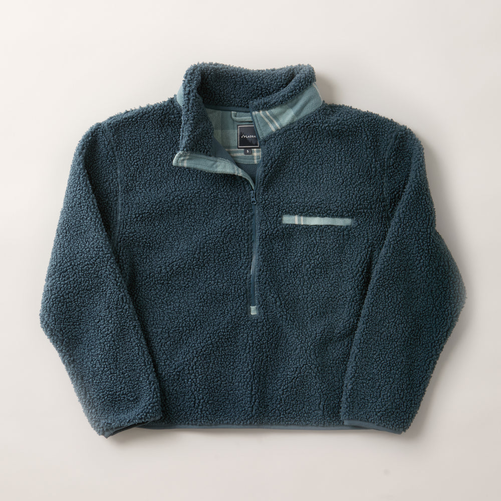The Women's Jenner Sherpa Fleece in Atlantic Blue is a long-sleeve pullover made from recycled polyester with a half-zip front, stand collar, small chest pocket, and light blue trim for added style.