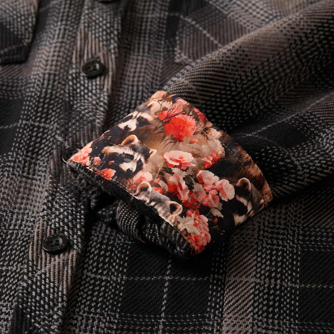Close-up of Pladra Women's Fireside Flannel in Cast Iron Black with cuff turned up, revealing floral and animal lining.