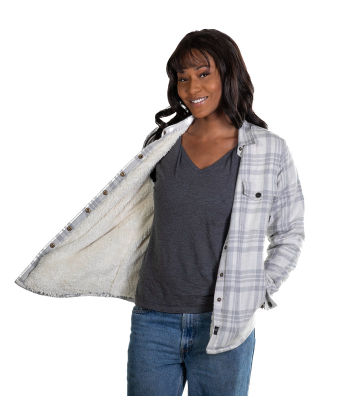 Woman smiling in jeans and a gray shirt, revealing the fuzzy lining of her Pladra Women&