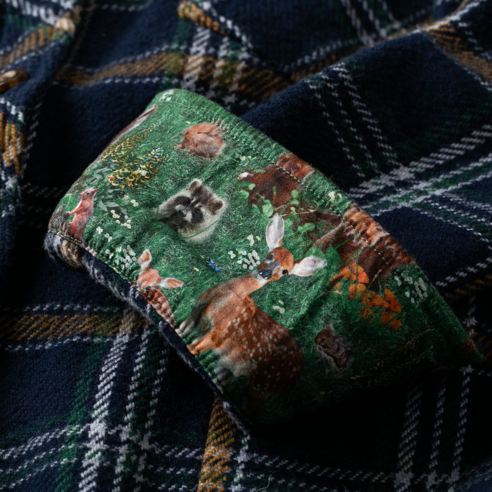 Pladra Women's Fireside Flannel in Feather Blue features cuffs with a forest animal print, including deer and raccoon.