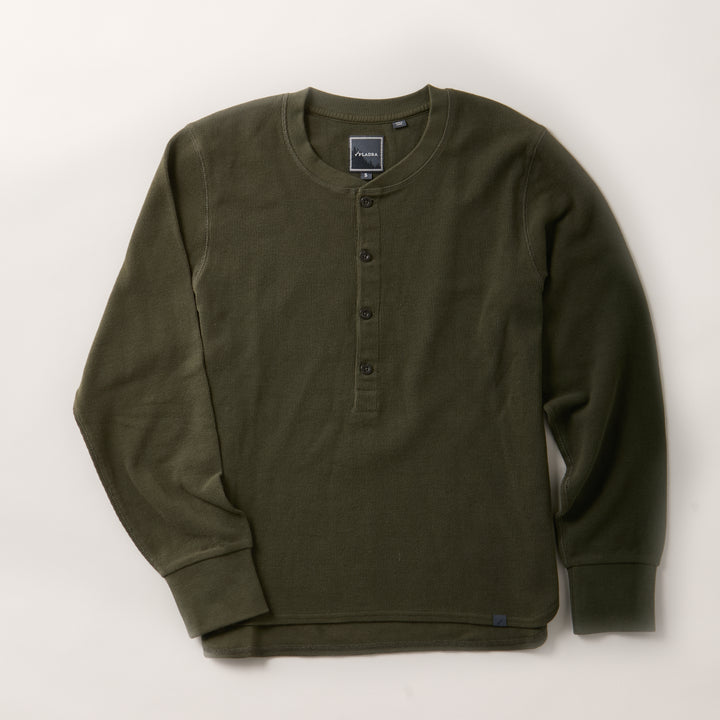 A women’s forest green Elko Henley, this mid-weight cotton shirt features long sleeves, a round neckline, and a four-button placket, shown laid flat on a light background.
