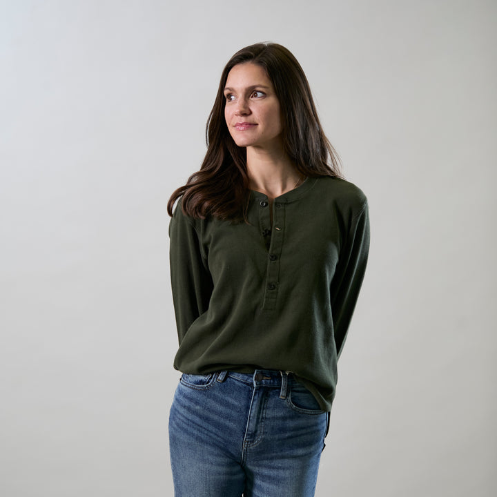 A woman with long brown hair, wearing the Women&