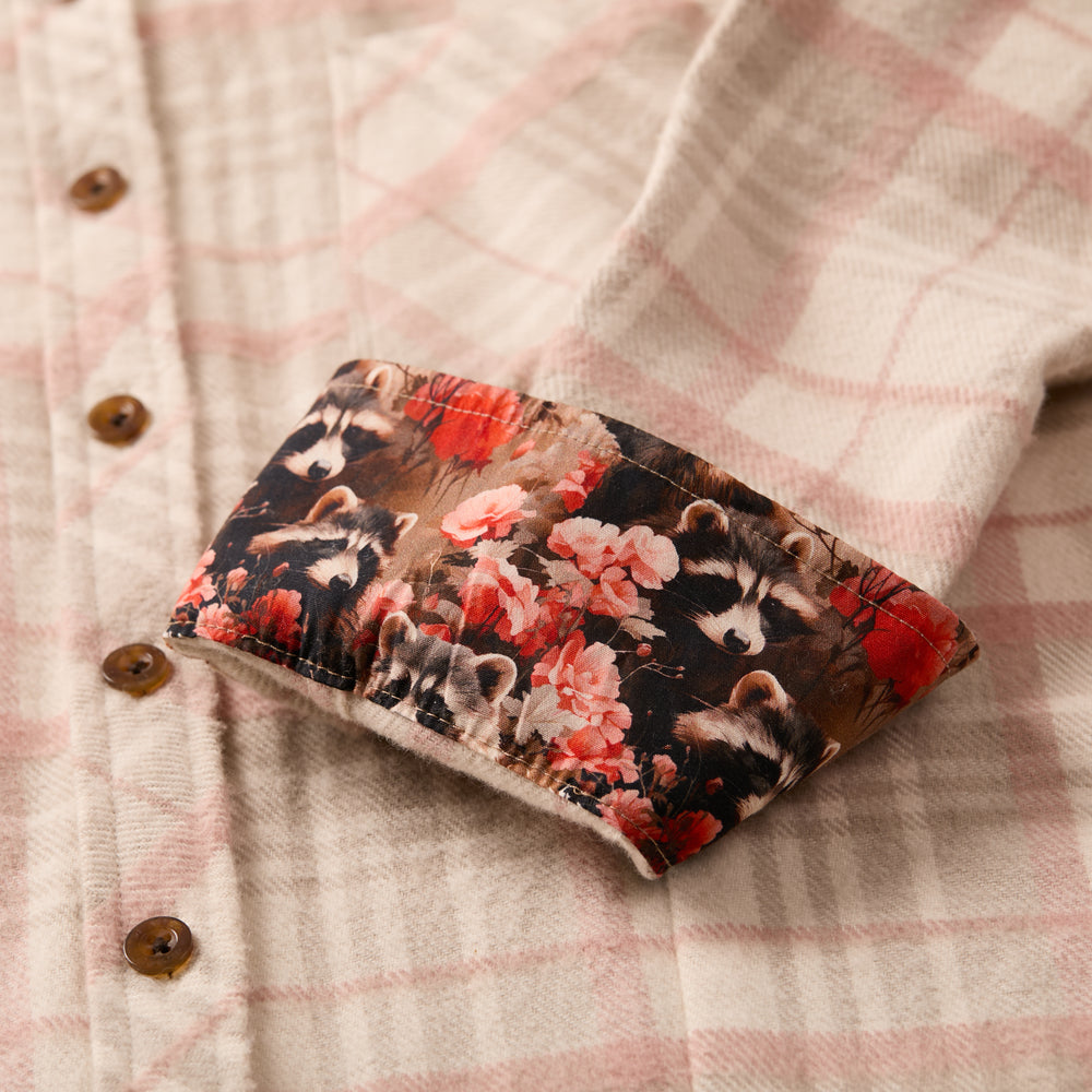 The Women's Every Day Elite Flannel Shirt in Lighthouse White features a beige and pink plaid, brown buttons, heavyweight brushed cotton, and turned-up cuffs lined with fabric printed with raccoons and red flowers.