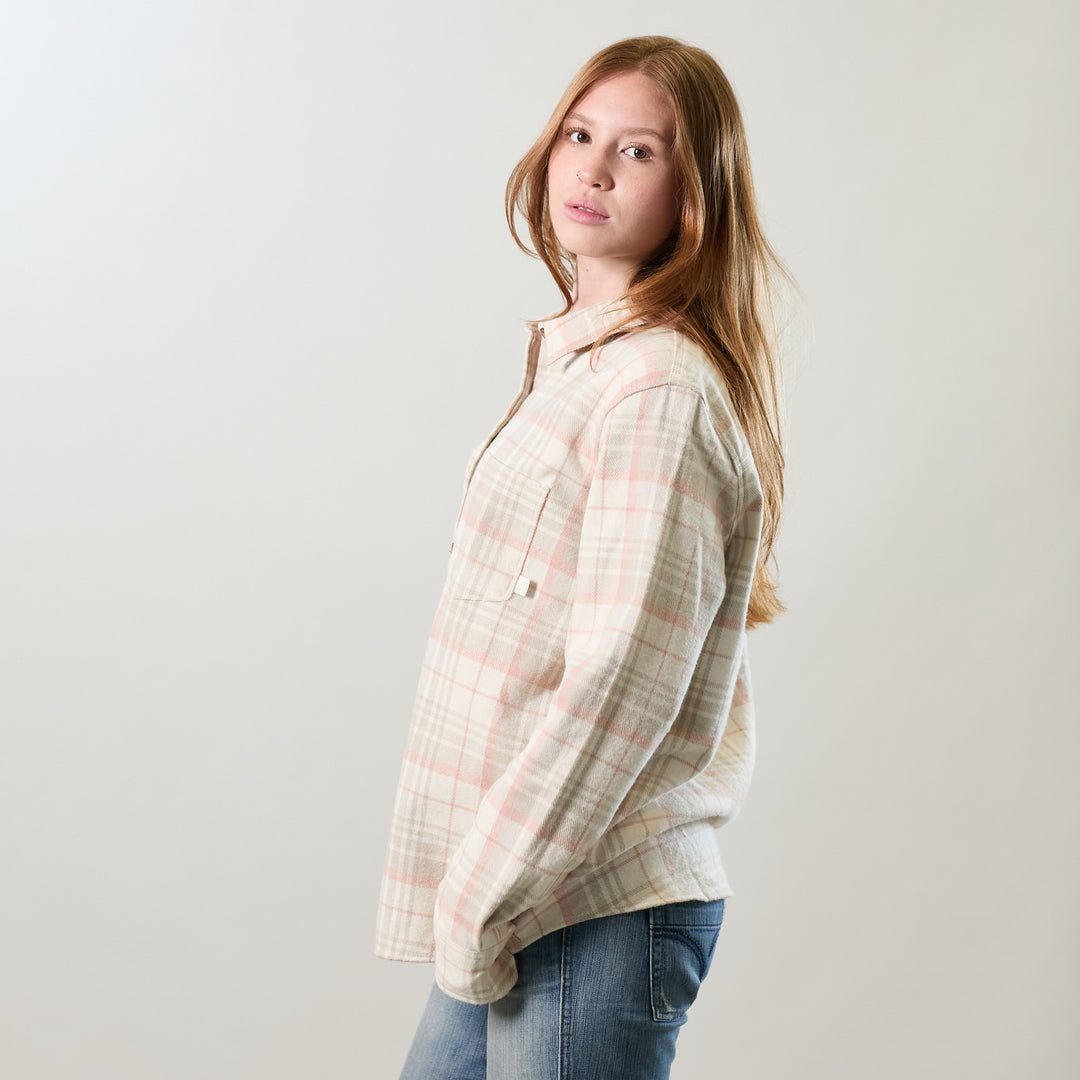 A young woman with long red hair, in jeans and a Women&