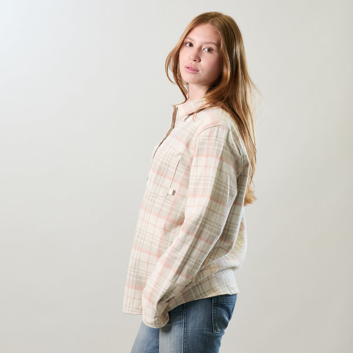 A young woman with long red hair, in jeans and a Women&