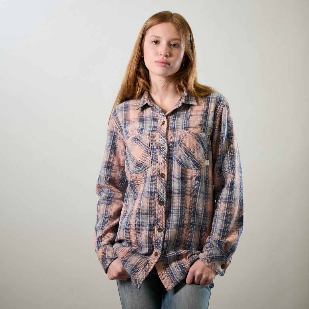 A young woman with long red hair wears the Pladra Women&
