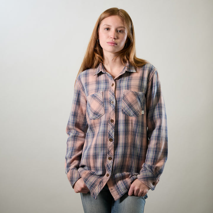 A young woman with long red hair wears the Pladra Women&