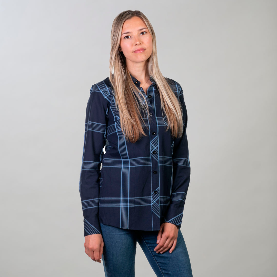 A woman with long blonde hair poses against a light gray background, wearing the Women&