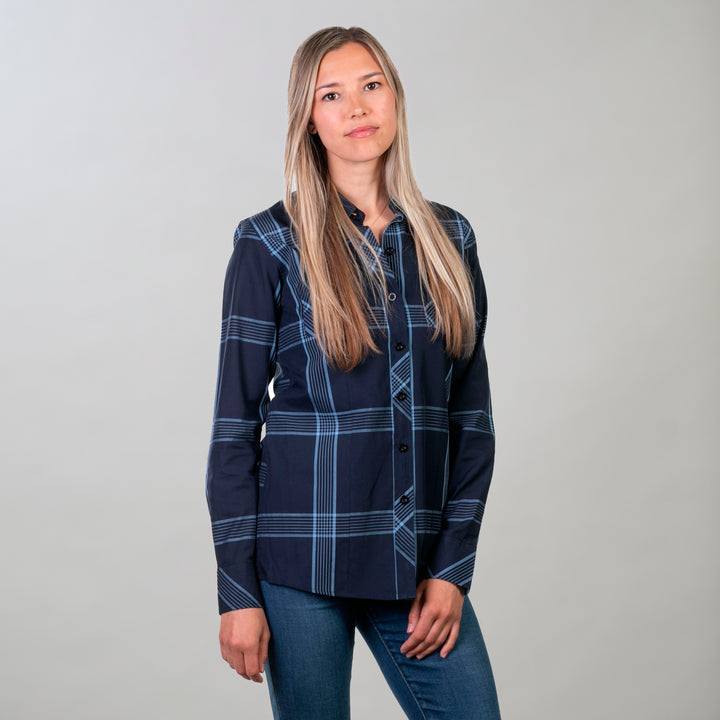 A woman with long blonde hair poses against a light gray background, wearing the Women&