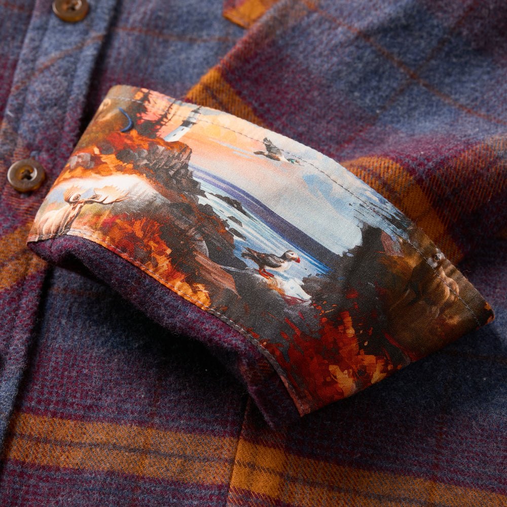 Close-up of Pladra Women's Every Day Flannel Shirt cuff in Portsmouth Blue Heather with plaid and landscape print.