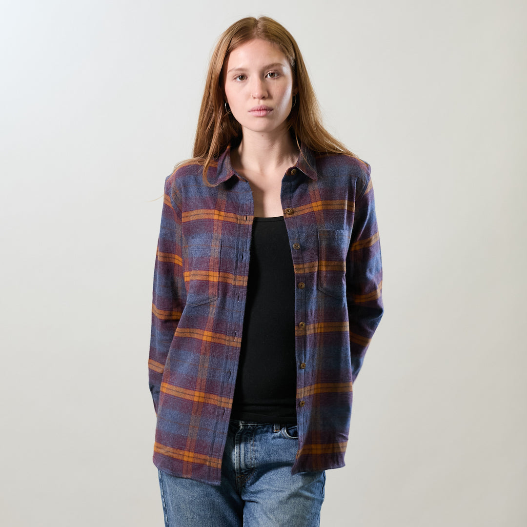 Woman with long hair in Pladra’s Relaxed Every Day Flannel Shirt—Portsmouth Blue Heather, over a black top and jeans.