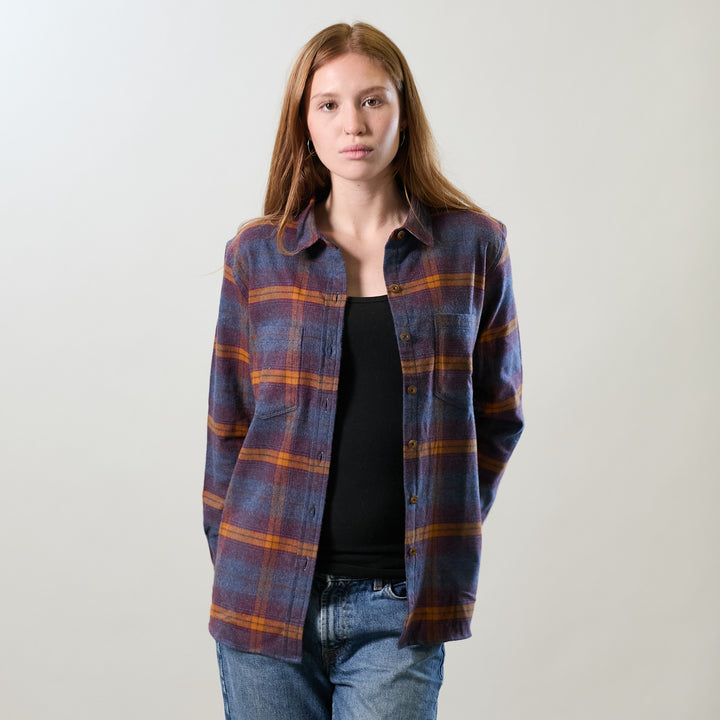 Woman with long hair in Pladra’s Relaxed Every Day Flannel Shirt—Portsmouth Blue Heather, over a black top and jeans.