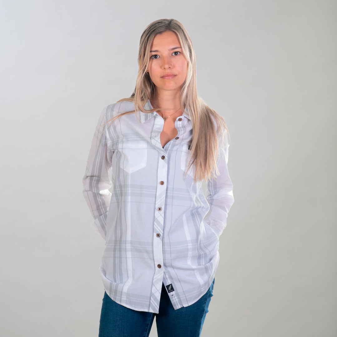 A woman with long blonde hair wears a Pladra Women's Breeze Shirt in Spring White and jeans against a light background.