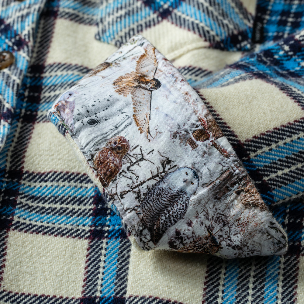An owl-patterned cloth rests on a Pladra Women's Fireside Flannel- Tahoe Tan background.