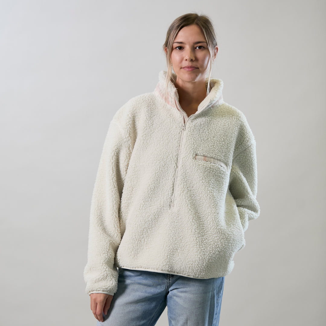 Woman in Pladra Women's Jenner Sherpa Fleece - Oatmeal White stands against a light background, looking at the camera.