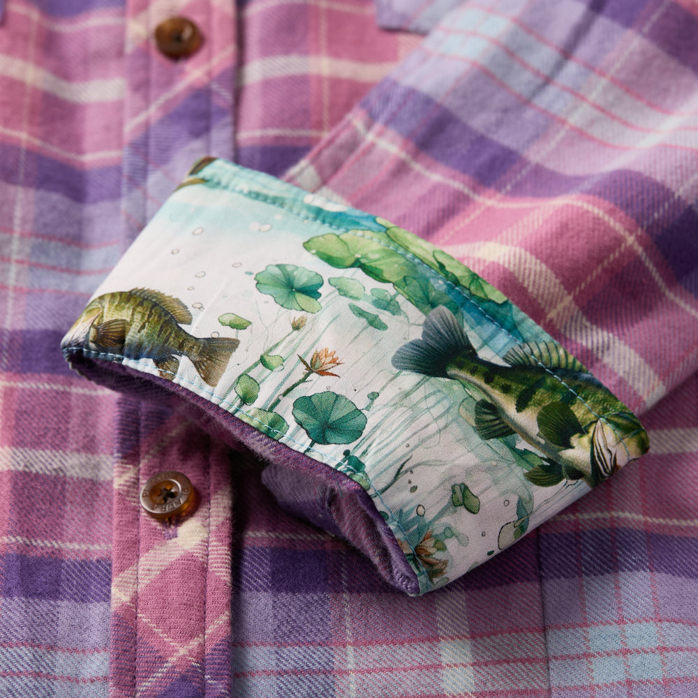 The Women's Every Day Flannel Shirt in Wildflower Pink by Pladra features rolled cuffs with a fish and lily pad pattern.